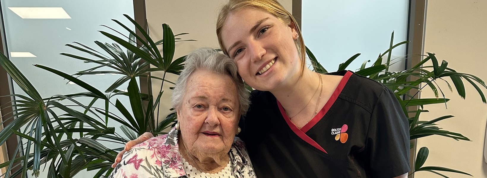 An elderly resident and young carer, smiling An elderly resident and young carer, smiling