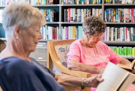 Two elderly females reading peacefully Two elderly females reading peacefully