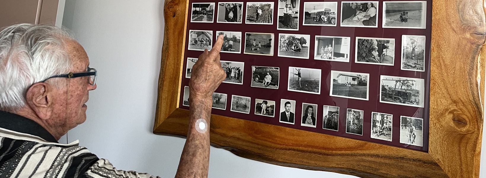 Frank looking through his photos from the early days of Caboolture.jpg Frank looking through his photos from the early days of Caboolture.jpg