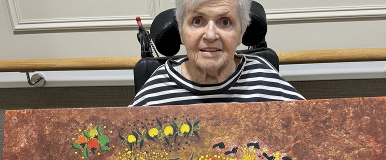 Jenny with one of her gifted paintings.jpg Jenny with one of her gifted paintings.jpg